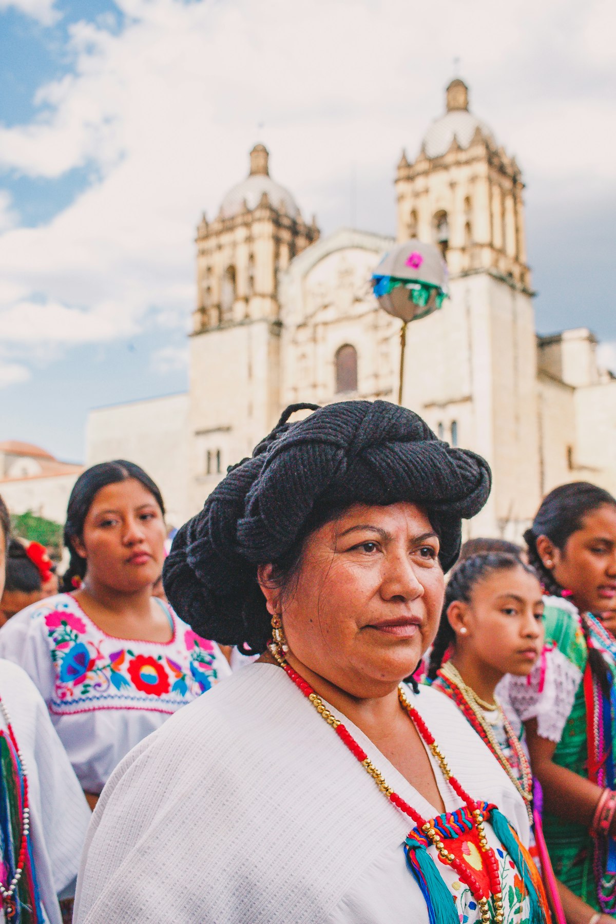 Local woman in traditional dress in front of Santo Domingo church, Oaxaca, Mexico