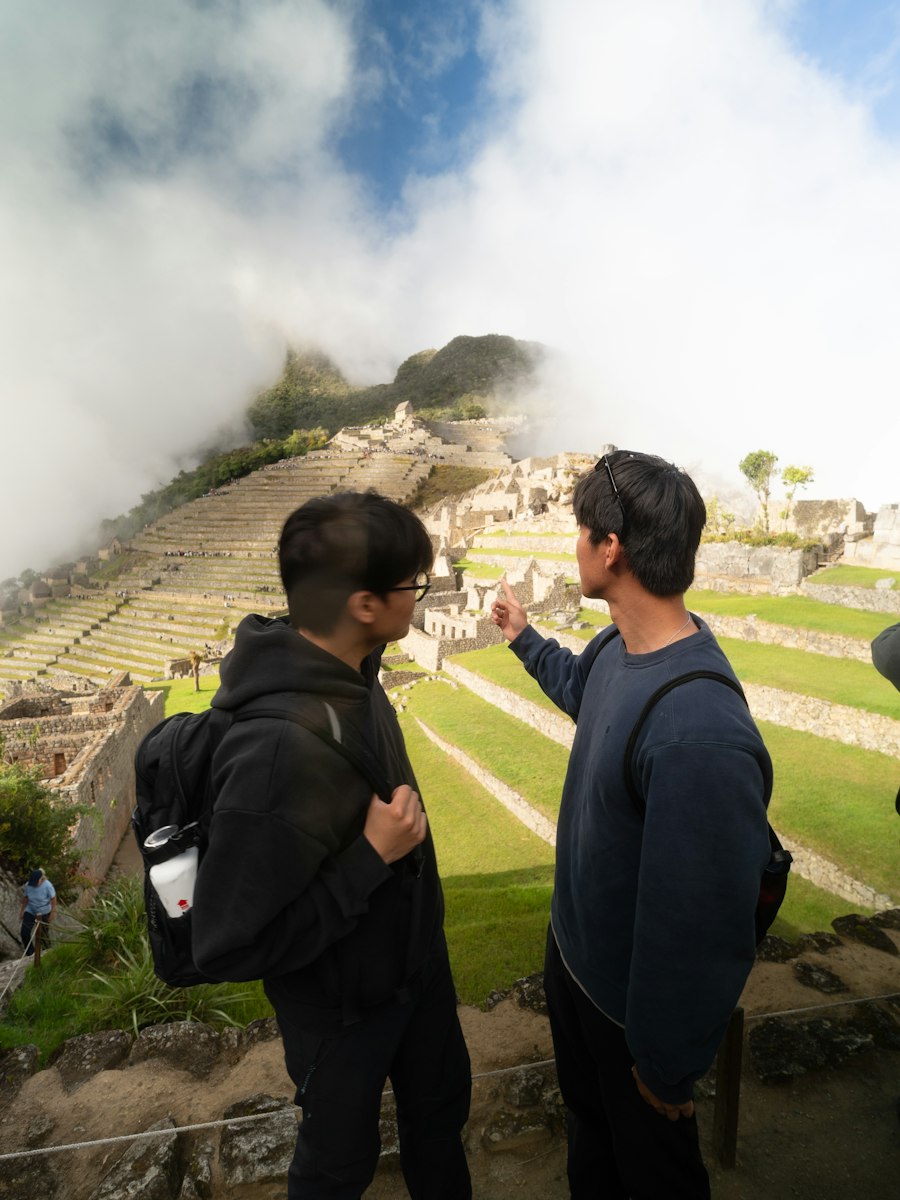 Students with backpacks exploring Machu Picchu, Peru
